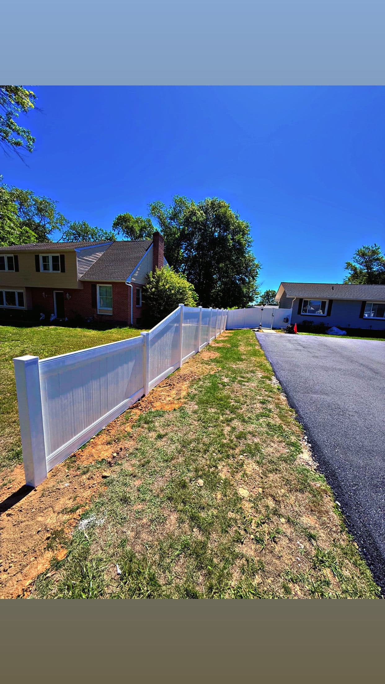 Project White Vinyl Privacy Fence With a Custom Height Transition image