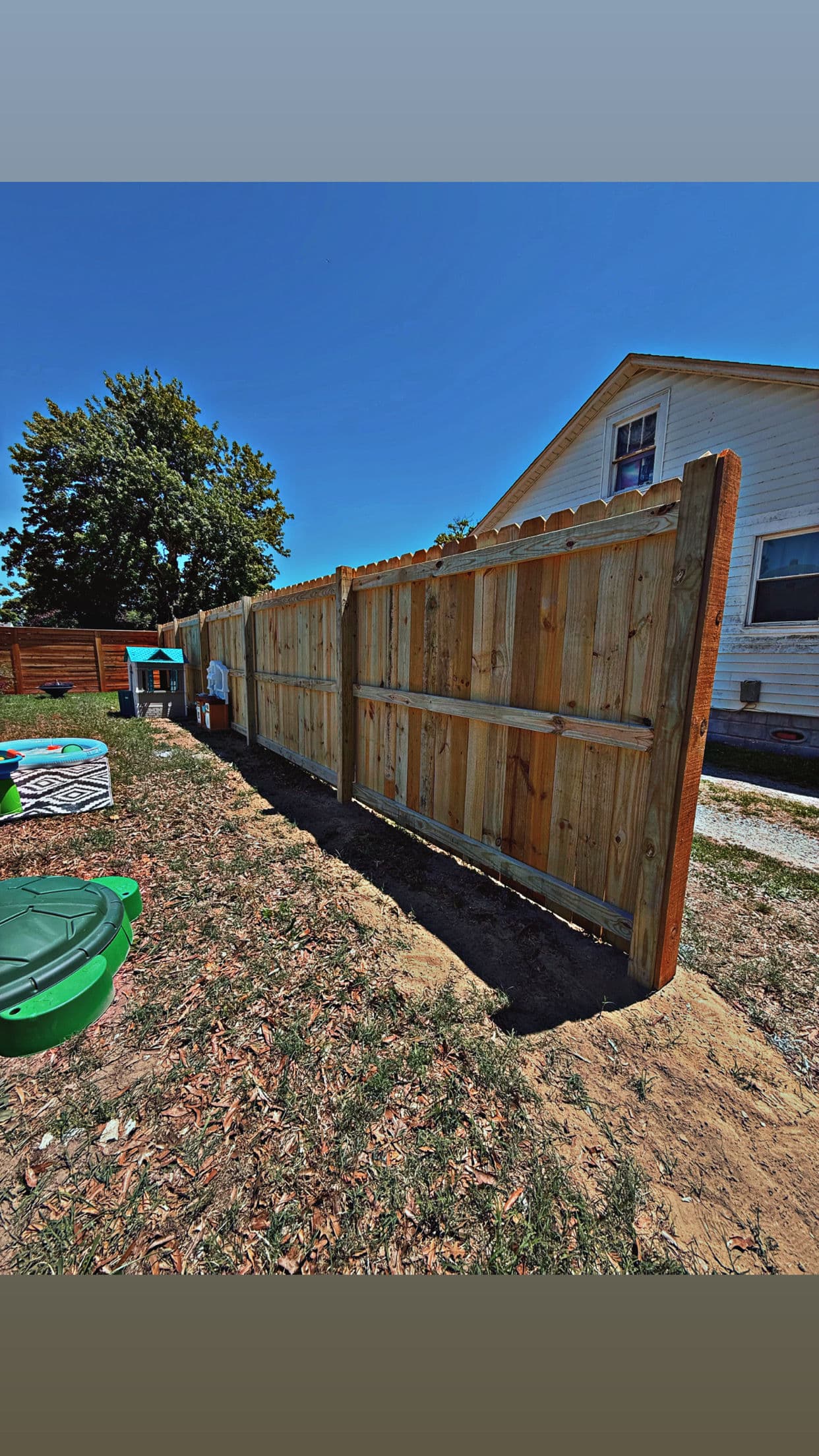 Pressure-Treated Wood Privacy Fence for a Family Backyard