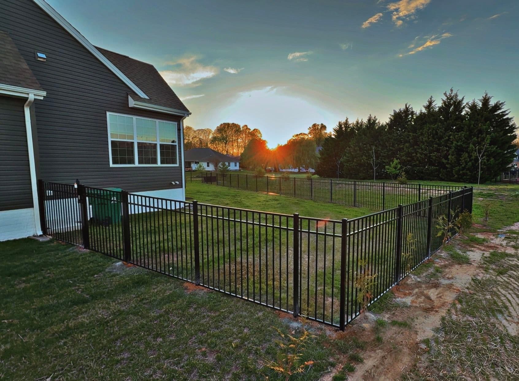 Black Three-Rail Aluminum Fence Installed Around Beautiful Backyard image